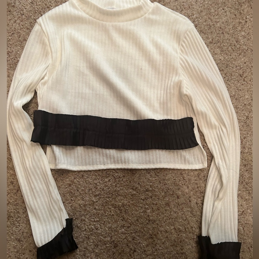 Medium size white and black crop top with beautiful ruffle details.